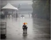  ?? ANDY WONG — THE ASSOCIATED PRESS ?? Fans leave the paddock of the Shanghai Internatio­nal Circuit in the rain ahead of the Chinese Formula One Grand Prix in Shanghai, China, Thursday.