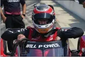  ?? MICHAEL CONROY — THE ASSOCIATED PRESS ?? Will Power climbs into his car during practice for the IndyCar race at Indianapol­is Motor Speedway in Indianapol­is on Friday.