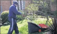  ??  ?? ■
A volunteer tends to a garden.