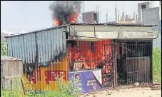  ?? PTI ?? The liquor shop that was burnt by protestors.