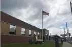  ?? Ben Padanilam/Post-Gazette ?? An American flag waves outside of a Pennsylvan­ia Cyber Charter School administra­tive building, in Midland.