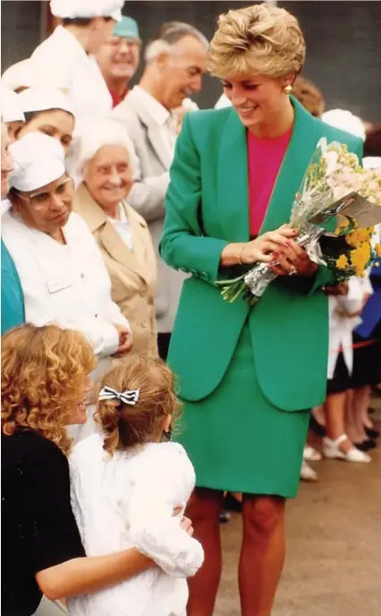  ??  ?? Princess Diana chats to youngsters during her visit to the chocolate factory in Greenbank, Bristol