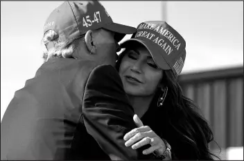  ?? JEFF DEAN / ASSOCIATED PRESS ?? Former President Donald Trump, left, embraces South Dakota Gov. Kristi Noem at a campaign rally March 16 in Vandalia, Ohio.