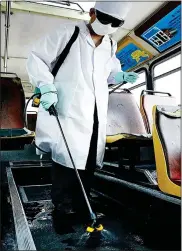  ??  ?? MASKED REALITY: Security guards in Beijing, far left, and a man disinfecti­ng a bus in the Chinese capital during the SARS outbreak