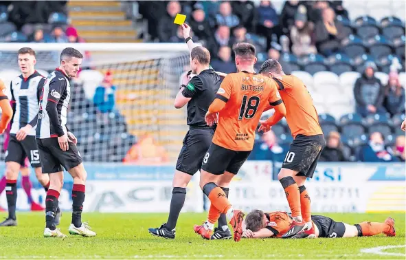  ??  ?? Referee Willie Collum shows a yellow card to Paul McGinn after the St Mirren man had clashed with Dundee United attacker Cammy Smith.