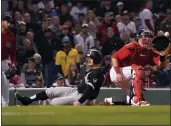  ?? MARY SCHWALM — THE ASSOCIATED PRESS ?? The White Sox's Adam Engel, center, scores ahead of a throw to Red Sox catcher Kevin Plawecki, right, on a sacrifice fly by Reese McGuire during the eighth inning at Fenway Park on Friday in Boston.