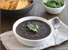  ?? GETTY IMAGES ?? Top this black bean soup with the garnishes of your choice, from fresh cilantro to diced sweet onions, hard-boiled eggs or even sliced banana.