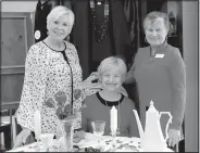  ?? NWA Democrat-Gazette/LYNN ATKINS ?? Kristy Danna (left) manages Audrey’s Resale Boutique in Bella Vista, which supports the nonprofit Audrey’s Home of Hope. Volunteers like Jane Kaylor (center) keep the shop open. Athelyn Buckley (right), an essential oil educator, was a special guest at the boutique last week. The boutique accepts donated clothes and household goods to resell. Anything that can’t be sold is donated to another nonprofit, Danna said. The shop can sometimes help individual­s referred to them by area churches.