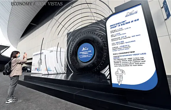  ??  ?? A giant Michelin’s XDR 3 tire is on display at the Michelin Group booth at the third China Internatio­nal Import Expo (CIIE) held in Shanghai, on November 5, 2020.
