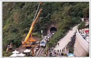  ?? (AP/Chiang Ying-ying) ?? Workers Saturday remove part of the train that derailed Friday near Taroko Gorge in Hualien, Taiwan. More photos at arkansason­line.com/44taiwan/.