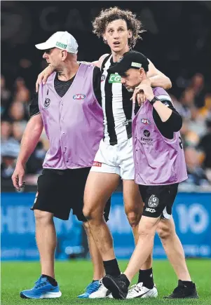  ?? Picture: GETTY IMAGES ?? Chris Mayne is helped from the field after a heavy knock.