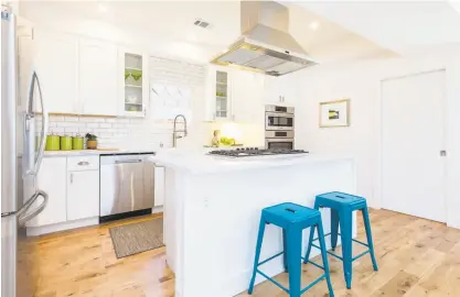  ?? Leila Seppa Photograph­y ?? The open kitchen features Carrera counters, Shaker cabinetry, and white subway tiles.