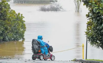  ?? Photos / AP ?? Flooded farmland on the outskirts of Sydney, Australia. Homes and roads in the city have been inundated and a cargo ship was saved after being caught in rough seas.