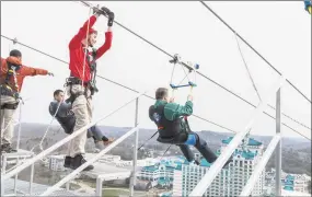  ?? Courtesy of Foxwoods ?? Attendants release Mashantuck­et Pequot Tribal Council Chairman Rodney Butler, left, and Foxwoods President and CEO Felix Rappaport to start their ride on HighFlyer.