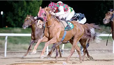  ??  ?? Connor Beasley rides Ahmed Al Meharbitra­ined Somoud towards the finish line to win the Al Ain Mile.