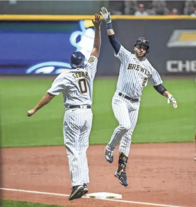  ?? BENNY SIEU / USA TODAY SPORTS ?? Brewers rightfielder Ryan Braun celebrates with third base coach Ed Sedar after Braun hit a three-run homer in the first inning against the Cardinals in Game 2 of their doublehead­er.