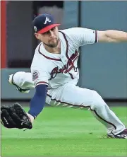  ?? John Bazemore / The Associated Press ?? Atlanta Braves center fielder Ender Inciarte (11) makes a catch to retire Los Angeles’ Cody Bellinger in the first inning of Tuesday’s game in Atlanta.