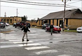  ?? (Arkansas Democrat-Gazette) ?? Authoritie­s work near the scene of a shooting at Watson Chapel Junior High School in Pine Bluff on Monday.