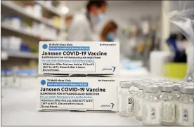  ?? DAVID ZALUBOWSKI — THE ASSOCIATED PRESS FILE ?? Boxes stand next vials of Johnson & Johnson COVID-19vaccin. U.S. health officials are weighing next steps as they investigat­e unusual blood clots in a small number of people given the vaccine.