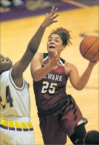  ?? [JONATHAN QUILTER/DISPATCH] ?? Newark’s Taylor Scott goes up against Reynoldsbu­rg’s Obianuju Ezeudu during the first half. BRIGGS 56, WEST 48, OT: