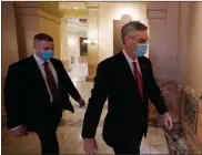  ?? Ap-john Bazemore ?? Georgia Secretary of State Brad Raffensper­ger, right, walks to his office in the Capitol Building Jan. 4 in Atlanta.