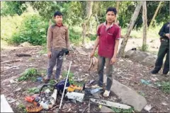  ?? SUPPLIED ?? Oum Ngat Say (left) and Sou Chan (right) were arrested on Friday for allegedly logging in a protected area of Pursat province.