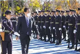  ?? KIYOSHI OTA AP ?? Japan’s Prime Minister Fumio Kishida (second from left) reviews an honor guard at the Japan Ground Self-defense Force Camp Asaka in Tokyo, Japan, Saturday.