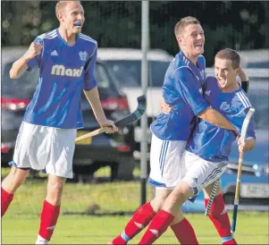  ?? Photo: Neil Paterson ?? Kyles Athletic’s Grant Irvine looks on as the two extra time goalscorer­s, Roberto Zavaroni and Gordon Whyte, celebrate the 3-2 win over Newtonmore in the Scottish Hydro Camanachd Cup semi-final
held at Taynuilt last Saturday