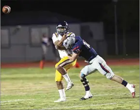  ??  ?? Ridgeview quarterbac­k Marcus Level just gets the ball off before being hit by Liberty defender Randon Reeder on March 26.