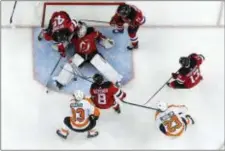 ?? JULIO CORTEZ — THE ASSOCIATED PRESS ?? New Jersey Devils goaltender MacKenzie Blackwood, center, falls back to the ice while trying to defend his net against the Philadelph­ia Flyers during the third period of an NHL hockey game, Saturday in Newark, N.J. The Devils won 3-2.