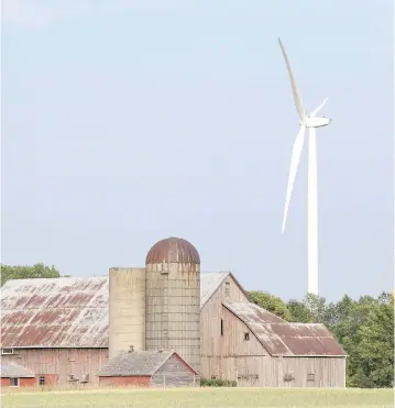  ?? LARS HAGBERG / THE CANADIAN PRESS ?? Wind turbines at the White Pines project near a farm in Milford, Ont. Doug Ford’s government in Ontario aims to cancel the contract for the project, which could drive away future investment in the province, John Ivison writes.