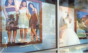  ?? WALT MANCINI, AP ?? The windows of an Alfred Angelo bridal store in West Covina, Calif., remained decorated July 14, a day after the company suddenly shut down all of its stores without notice.