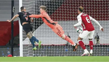  ?? — AP ?? As strong as they can get: Manchester City’s Gabriel Jesus (left) heads the ball past Arsenal goalkeeper Runar Alex Runarsson during the English League Cup quarter-final match in December.