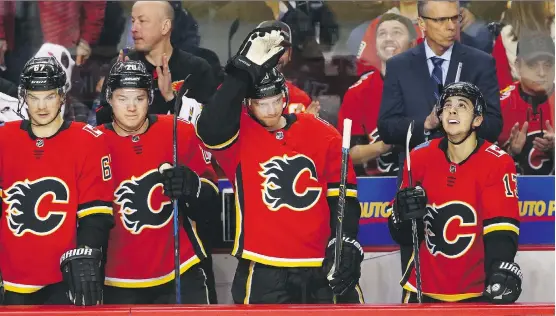  ?? JIM WELLS ?? Playing in his 1,000th NHL game, Flames forward Matt Stajan acknowledg­es the fans’ applause during Wednesday night’s game against the Anaheim Ducks at the Saddledome.