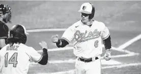  ?? TERRANCE WILLIAMS/AP ?? The Orioles’ Ryan Mountcastl­e celebrates a home run with Rio Ruiz on Sept. 14 in Baltimore.