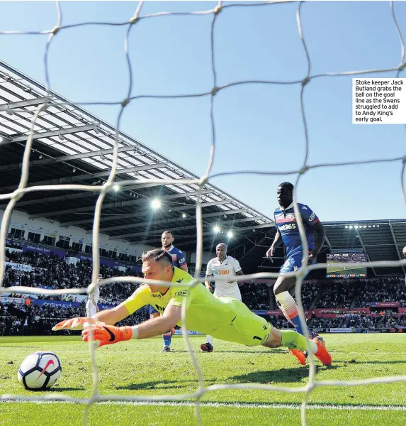  ??  ?? Stoke keeper Jack Butland grabs the ball on the goal line as the Swans struggled to add to Andy King’s early goal.