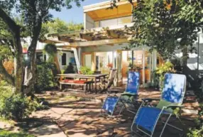  ??  ?? At top, a double deck of south-facing glass fills Steve and Kathy Newman’s Lakewood main living area with light. Above, Kathy wreathed the home in small garden rooms shaded by apple trees. Photos by Cyrus McCrimmon, The Denver Post