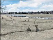  ?? Jackie Hutchins / Loveland Reporter-herald ?? Rock sculptures stand on the swim beach at Lake Loveland on Wednesday morning, April 15, 2020, as Laura Fagette of Loveland and her mother Claudia Ward and children Hazel, 5, and Wyatt, 3, walk on the beach in the background.