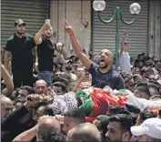  ?? Majdi Mohammed Associated Press ?? PALESTINIA­NS carry the body of Islam Sabouh, who was killed during an operation by Israeli forces.