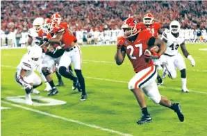  ?? THE ASSOCIATED PRESS ?? Georgia running back Nick Chubb breaks away to score a touchdown against Mississipp­i State during the second half of Saturday’s game in Athens, Ga. The Bulldogs won 31-3.
