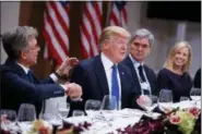  ?? EVAN VUCCI - THE ASSOCIATED PRESS ?? President Donald Trump listens during a dinner with European business leaders at the World Economic Forum, Thursday, Jan. 25, 2018, in Davos. From left, SAP CEO Bill McDermott, Trump, CEO of Seimens Joe Kaeser, and Secretary of Homeland Security...