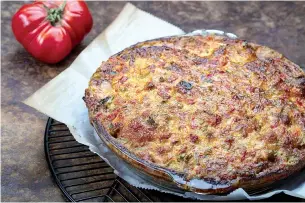  ?? Tribune News Service ?? ■ For Tomato Pie with Pimiento Cheese Topping, tomatoes are roasted in the oven to remove most of their water, then layered in a crust with cheese, basil and cracker crumbs and spread with a cheese, pimiento and mayo topping.