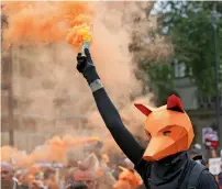  ?? AP file ?? A protester dressed as a fox demonstrat­es to keep a ban on fox hunting near the Houses of Parliament in London. —