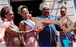  ??  ?? King Momo ( the symbol of carnival) Milton Junior, shows the key to the city of Rio, during the carnival official opening ceremony in Rio de Janeiro, Brazil, on Friday. Rio’s famous carnival opened Friday with Mayor Marcelo Crivella having to defend...