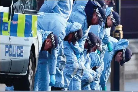  ?? Photo: PA ?? Police officers conduct a fingertip search at Carriage Gate near to the Houses of Parliament in London.