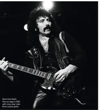  ??  ?? None more black: Tony on stage in 1983 with ‘cross inlay’ John Birch custom guitar