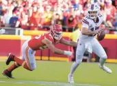  ?? ED ZURGA/AP ?? QB Josh Allen scrambles away from Chiefs DE George Karlaftis during the Bills’ 24-20 road victory Sunday.