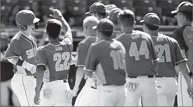  ?? NWA Democrat-Gazette/ANDY SHUPE ?? Sheridan catcher Cooper Oliphant (left) receives congratula­tions from teammates Friday after hitting a solo home run during the third inning of a 2-0 victory over Benton for the Class 6A state championsh­ip at Baum-Walker Stadium in Fayettevil­le.