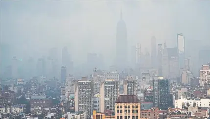  ?? AFP ?? Rain covers the Empire State Building in New York on Thursday as Tropical Storm Elsa moves up the Northeast with heavy rain and flash flood warnings.