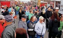  ?? ARCHIVES] [PHOTO BY DOUG HOKE, THE OKLAHOMAN ?? A crowd gathers between the food trucks during a Heard on Hurd earlier this year in downtown Edmond.